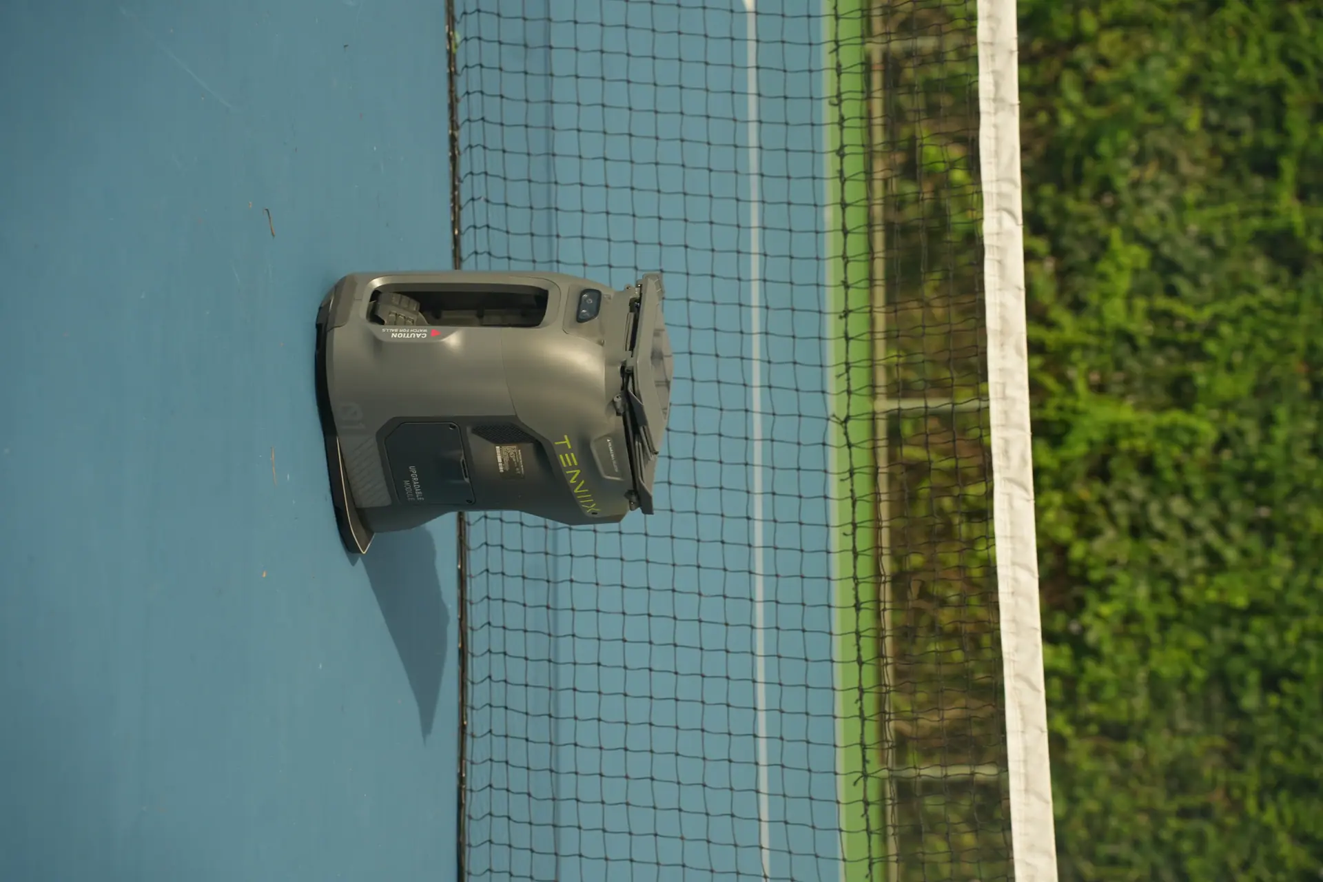 A quiet, empty tennis court with the net – the court sits unused, no slot free.